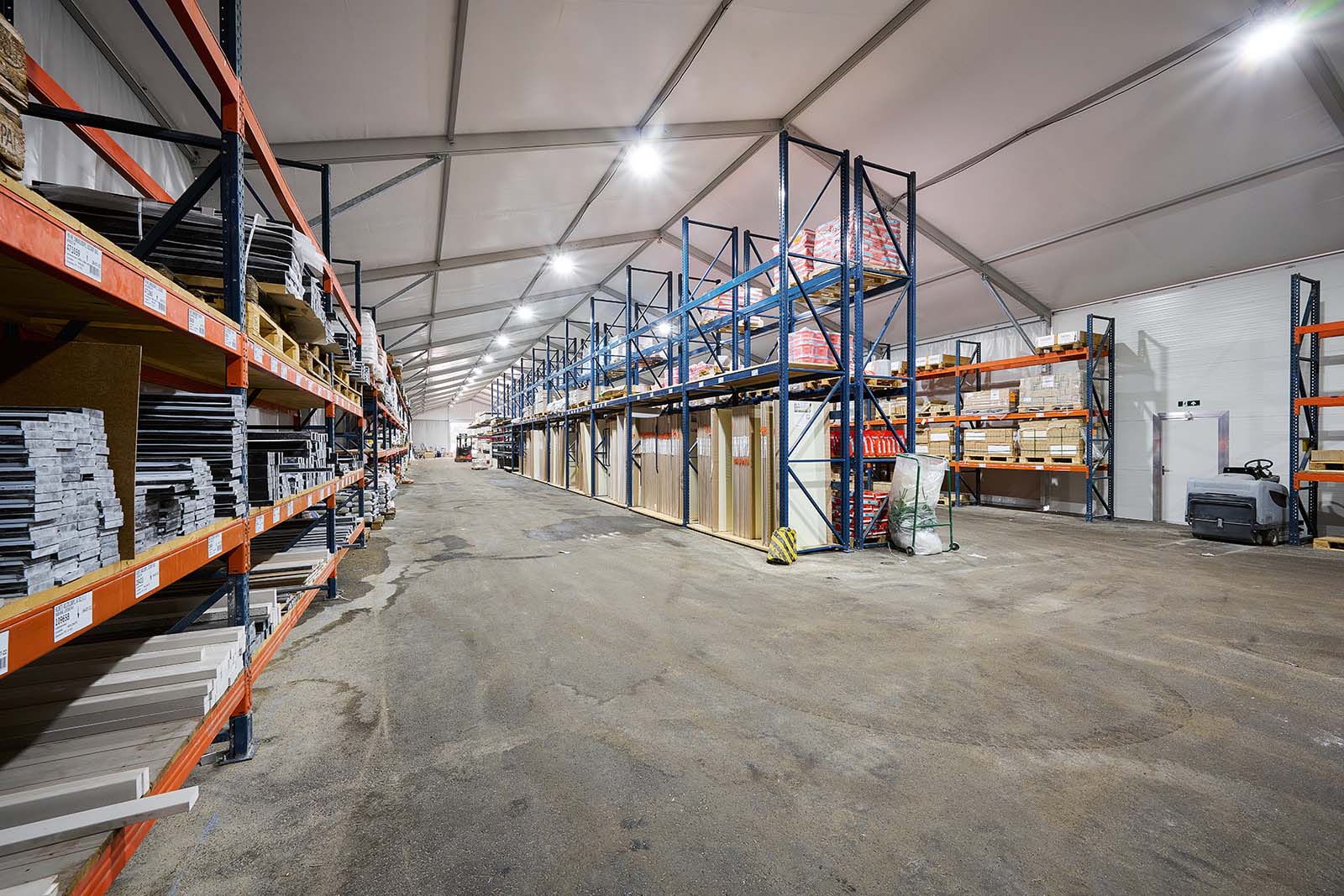 Een magazijntent met stellages met opslag BMN bouwmaterialen